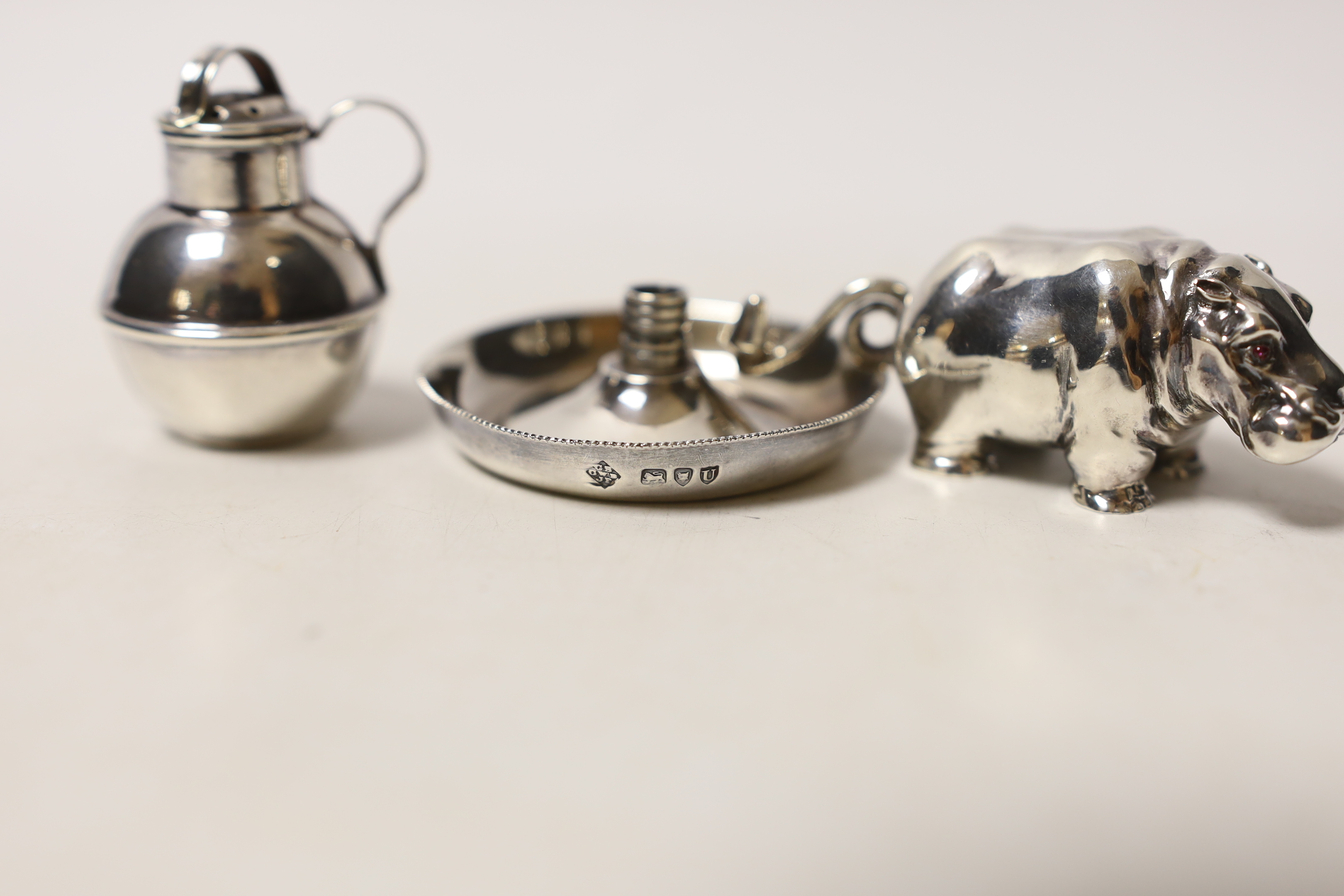 A modern silver miniature model of a hippopotamus, a white metal 'Guernsey can' pepperette and a part of a late Victorian silver small chamberstick.